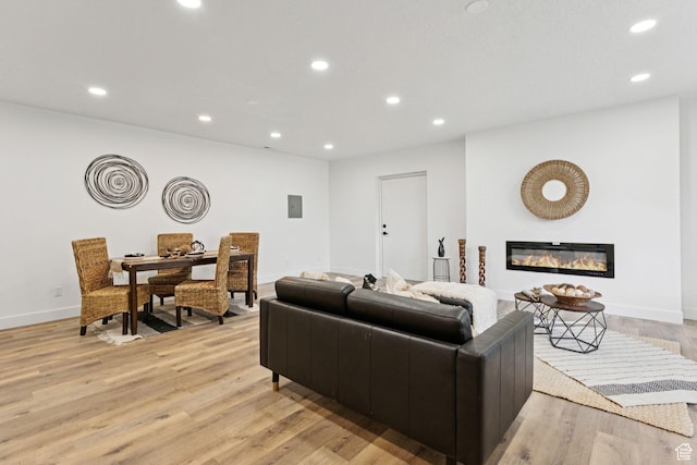 147 E 1700 S, Orem, UT 84058 - living area with light wood-type flooring, recessed lighting, and a glass covered fireplace