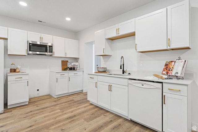 147 E 1700 S, Orem, UT 84058 - kitchen with stainless steel microwave, dishwasher, recessed lighting, light wood-style floors, and white cabinets