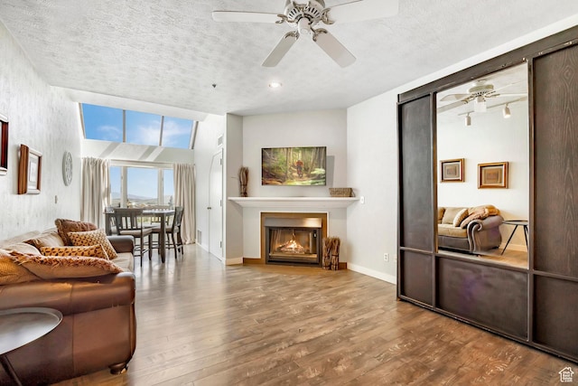 1415 Lowell Ave Unit 160, Park City, UT 84060 - living area with a ceiling fan, wood finished floors, a textured ceiling, and a glass covered fireplace