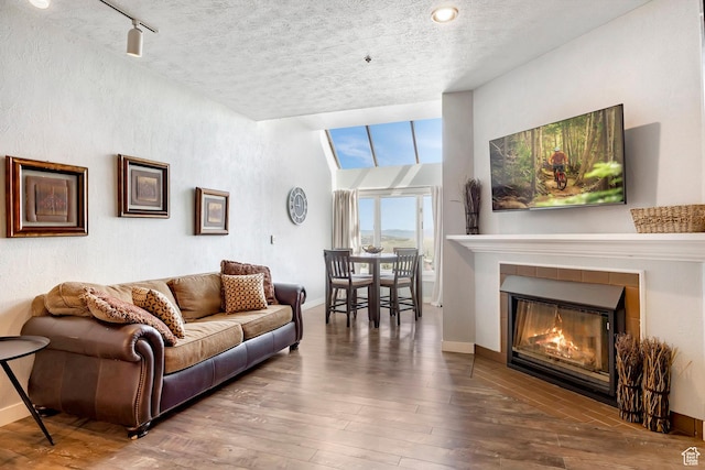 1415 Lowell Ave Unit 160, Park City, UT 84060 - living room featuring a tile fireplace, hardwood / wood-style floors, and a textured ceiling