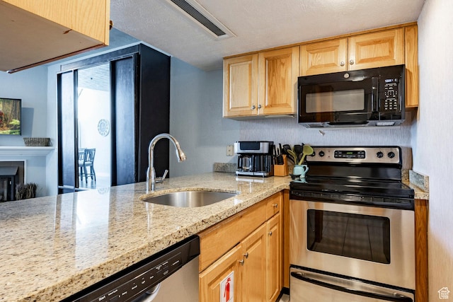 1415 Lowell Ave Unit 160, Park City, UT 84060 - kitchen with appliances with stainless steel finishes, light stone countertops, light brown cabinets, and a glass covered fireplace