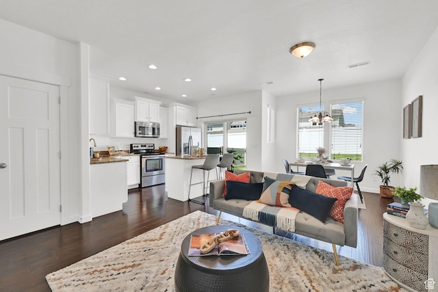 258 W 710 N, Centerville, UT 84014 - living room featuring dark wood-style floors, a chandelier, and recessed lighting