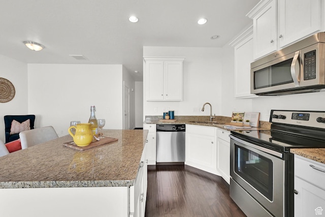 258 W 710 N, Centerville, UT 84014 - kitchen with stainless steel appliances, a center island, white cabinets, dark wood-style floors, and recessed lighting