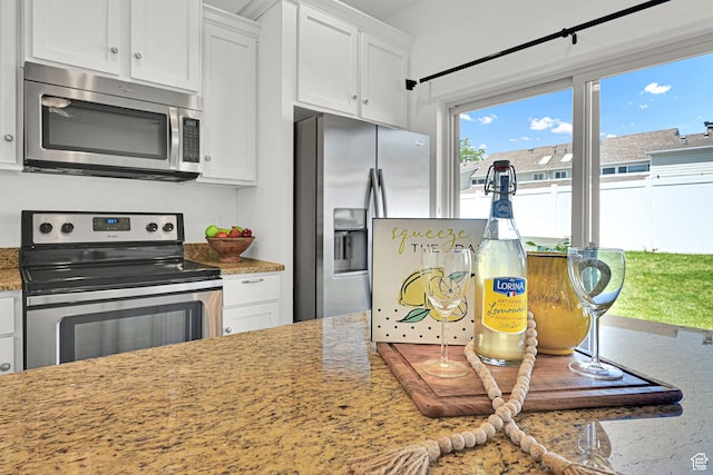 258 W 710 N, Centerville, UT 84014 - kitchen with stainless steel appliances, white cabinetry, and light stone countertops
