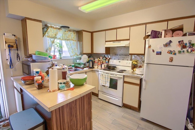 1714 E 5825 S, South Ogden, UT 84403 - kitchen with white appliances, under cabinet range hood, light countertops, a peninsula, and tasteful backsplash