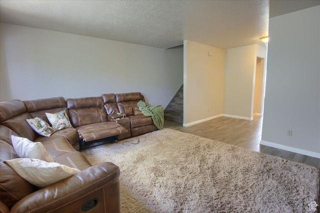 1714 E 5825 S, South Ogden, UT 84403 - living area with wood finished floors, stairway, and a textured ceiling