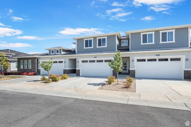 1371 W Stewart Falls Dr, Riverton, UT 84065 - view of front of house with stone siding, driveway, and a garage