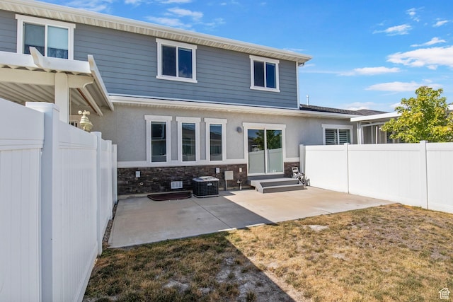 1371 W Stewart Falls Dr, Riverton, UT 84065 - back of property with a patio area, stone siding, and stucco siding