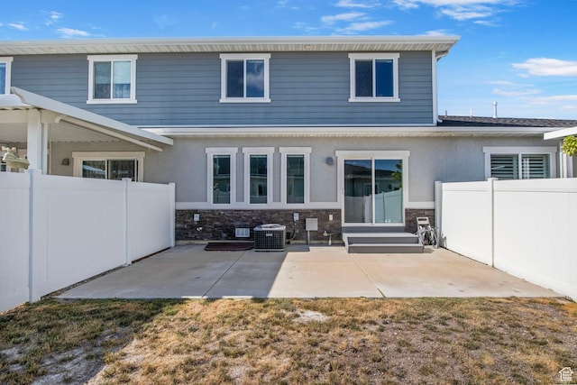 1371 W Stewart Falls Dr, Riverton, UT 84065 - back of house with stone siding, a patio area, and stucco siding