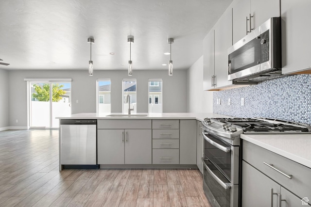 1371 W Stewart Falls Dr, Riverton, UT 84065 - kitchen with stainless steel appliances, gray cabinets, a peninsula, and open floor plan