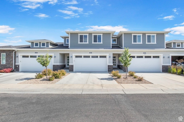 1371 W Stewart Falls Dr, Riverton, UT 84065 - view of front of property featuring stone siding, driveway, and a garage