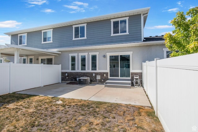 1371 W Stewart Falls Dr, Riverton, UT 84065 - rear view of house with a patio, entry steps, stone siding, and stucco siding