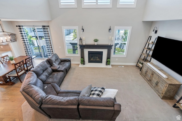 6462 W Shawnee Marie Way, Herriman, UT 84096 - living area with a high ceiling, a fireplace with flush hearth, and plenty of natural light