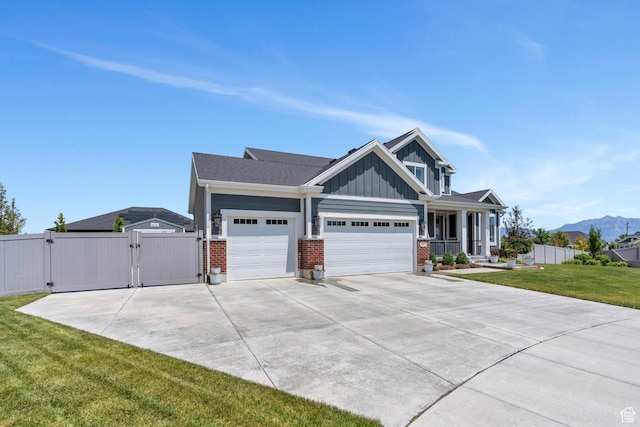 6462 W Shawnee Marie Way, Herriman, UT 84096 - view of front of property with a gate, board and batten siding, a garage, brick siding, and concrete driveway