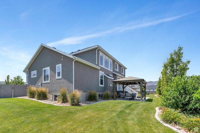 6462 W Shawnee Marie Way, Herriman, UT 84096 - back of property with a gazebo, stucco siding, a gate, and a patio area
