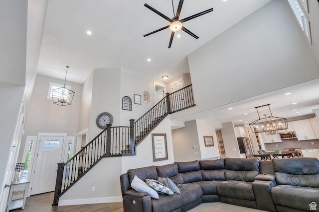 6462 W Shawnee Marie Way, Herriman, UT 84096 - living room with a high ceiling, a chandelier, stairway, recessed lighting, and a ceiling fan