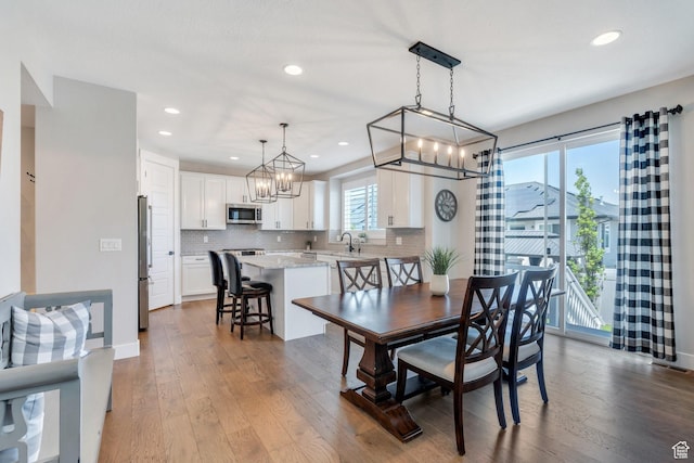 6462 W Shawnee Marie Way, Herriman, UT 84096 - dining room featuring a chandelier, dark wood-style flooring, and recessed lighting