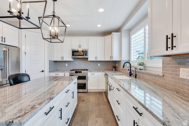 6462 W Shawnee Marie Way, Herriman, UT 84096 - kitchen featuring stainless steel appliances, a chandelier, light wood-style flooring, backsplash, and recessed lighting