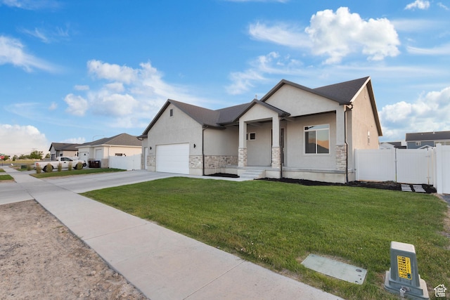 5057 N Foxtail W, Eagle Mountain, UT 84005 - view of front facade with stone siding, concrete driveway, stucco siding, and a garage