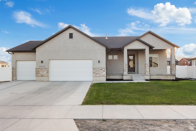 5057 N Foxtail W, Eagle Mountain, UT 84005 - view of front facade with stone siding, a garage, stucco siding, driveway, and a porch