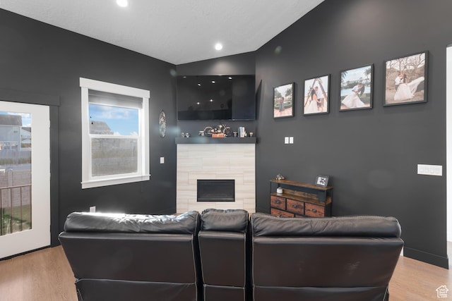 5057 N Foxtail W, Eagle Mountain, UT 84005 - living area featuring wood finished floors, a fireplace, vaulted ceiling, and recessed lighting