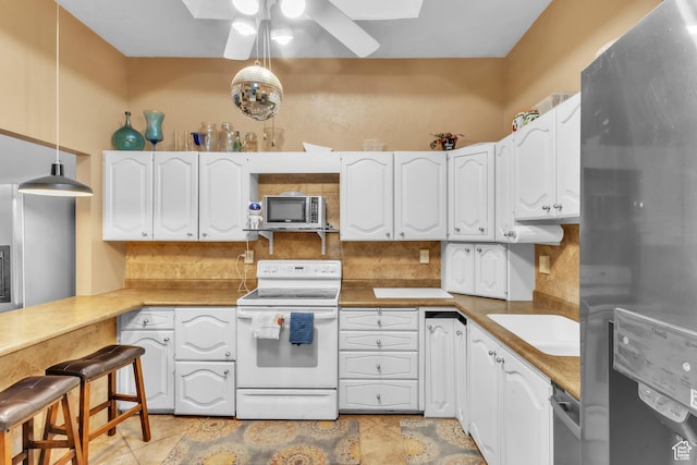 1876 E Casino Way S, Murray, UT 84121 - kitchen featuring appliances with stainless steel finishes, decorative backsplash, ceiling fan, and white cabinetry