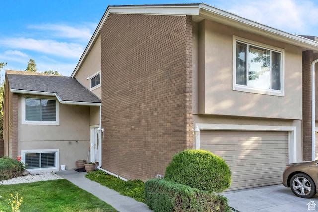 1876 E Casino Way S, Murray, UT 84121 - view of front of home featuring stucco siding, brick siding, concrete driveway, and a garage