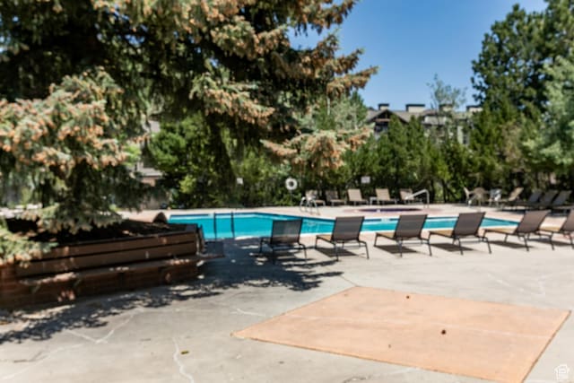 2100 Canyons Resort Dr Unit 21C, Park City, UT 84098 - community pool with a patio area and view of scattered trees