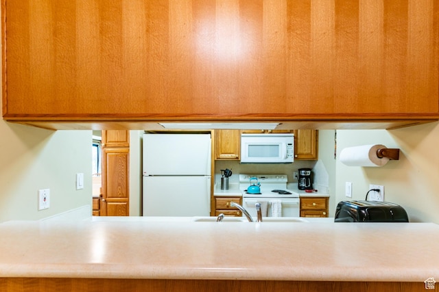 2100 Canyons Resort Dr Unit 21C, Park City, UT 84098 - kitchen with white appliances, a peninsula, light countertops, and brown cabinets