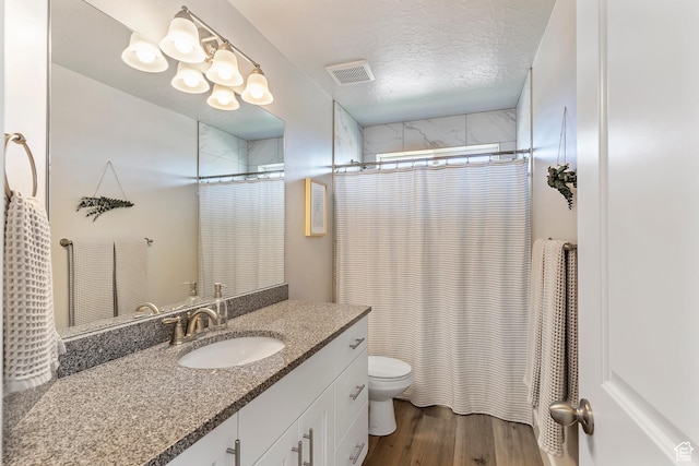 269 Cook Ln, Grantsville, UT 84029 - full bath with vanity, wood finished floors, a shower with curtain, and a textured ceiling