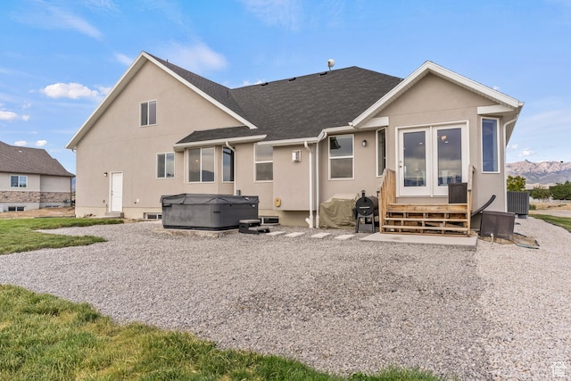 269 Cook Ln, Grantsville, UT 84029 - back of house featuring a hot tub, stucco siding, and roof with shingles