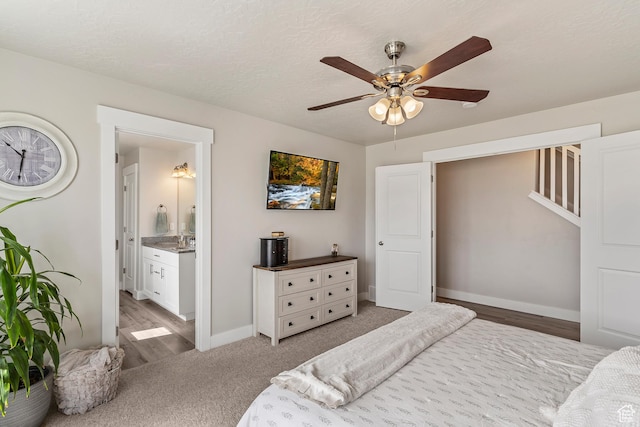 269 Cook Ln, Grantsville, UT 84029 - bedroom with light wood-style flooring, ceiling fan, ensuite bath, and light colored carpet