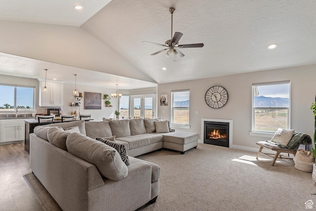 269 Cook Ln, Grantsville, UT 84029 - living area with a glass covered fireplace, a ceiling fan, vaulted ceiling, recessed lighting, and a chandelier