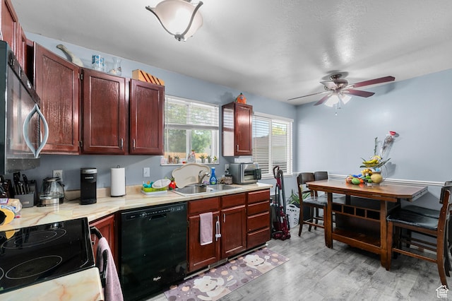 5370 W Cadenza Dr S, West Jordan, UT 84081 - kitchen with black appliances, light countertops, ceiling fan, light wood-type flooring, and reddish brown cabinets