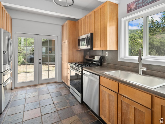 4410 S Upper Aspen Loop Unit 130, Kamas, UT 84036 - kitchen featuring appliances with stainless steel finishes, stone tile flooring, french doors, and healthy amount of natural light