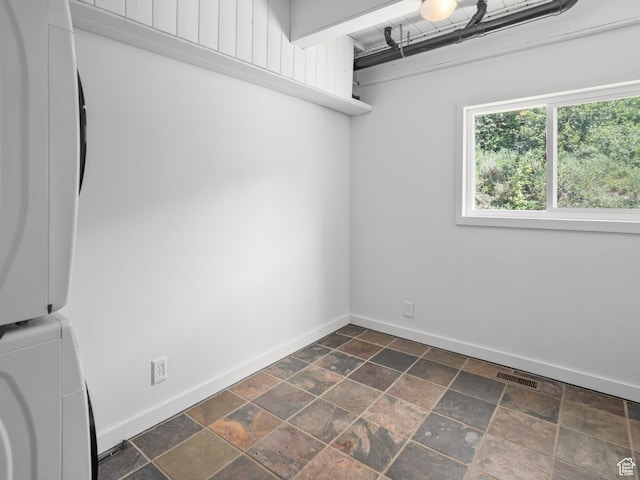 4410 S Upper Aspen Loop Unit 130, Kamas, UT 84036 - laundry room featuring estacked washer and dryer and dark stone finish flooring
