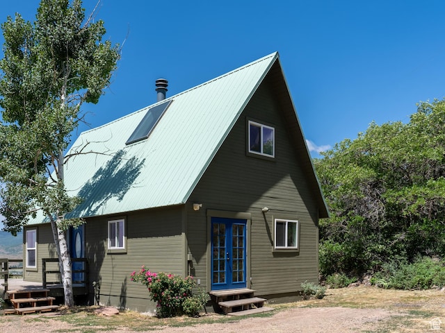 4410 S Upper Aspen Loop Unit 130, Kamas, UT 84036 - view of front of house featuring french doors, a deck, and a metal roof