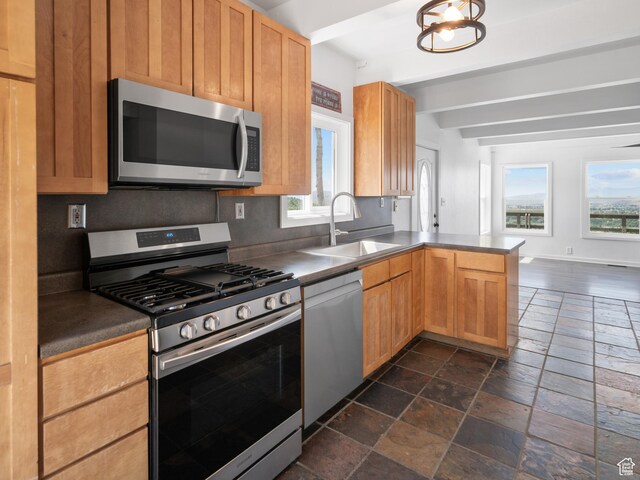 4410 S Upper Aspen Loop Unit 130, Kamas, UT 84036 - kitchen with stainless steel appliances, stone tile floors, a peninsula, dark countertops, and beam ceiling
