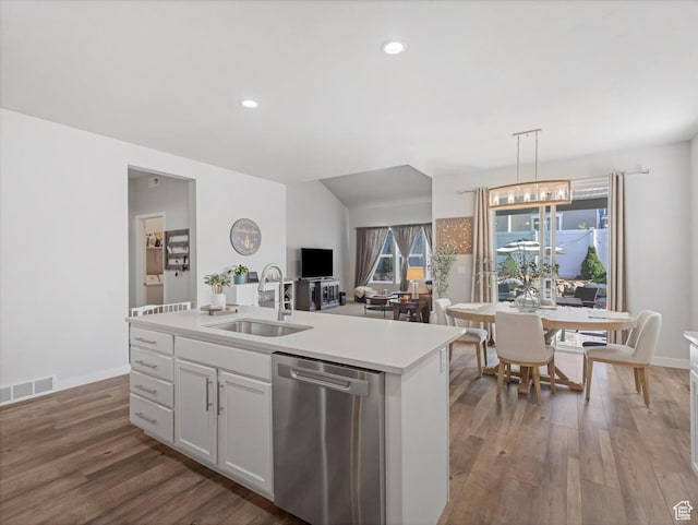6612 W Terrace Wash Ln S Unit 119, West Jordan, UT 84081 - kitchen with stainless steel dishwasher, wood finished floors, light countertops, white cabinets, and decorative light fixtures