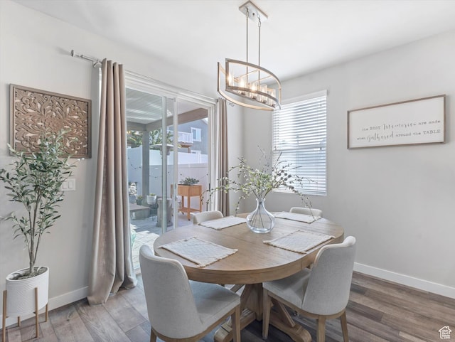 6612 W Terrace Wash Ln S Unit 119, West Jordan, UT 84081 - dining area featuring a chandelier, plenty of natural light, and wood finished floors