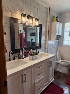 3035 Brinker Ave, Ogden, UT 84403 - full bathroom with double vanity, tile walls, and wood finished floors