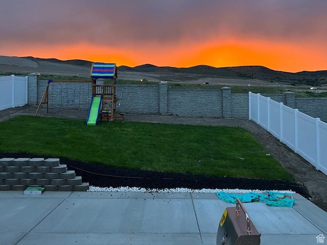2563 N Velvet Moon Dr W Unit 625, Saratoga Springs, UT 84045 - fenced backyard featuring a playground and a mountain view