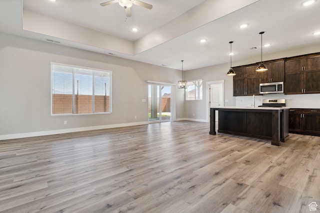 1213 E Marlowe Way, Washington, UT 84780 - kitchen featuring stainless steel microwave, range, light wood-style flooring, dark brown cabinets, and a ceiling fan