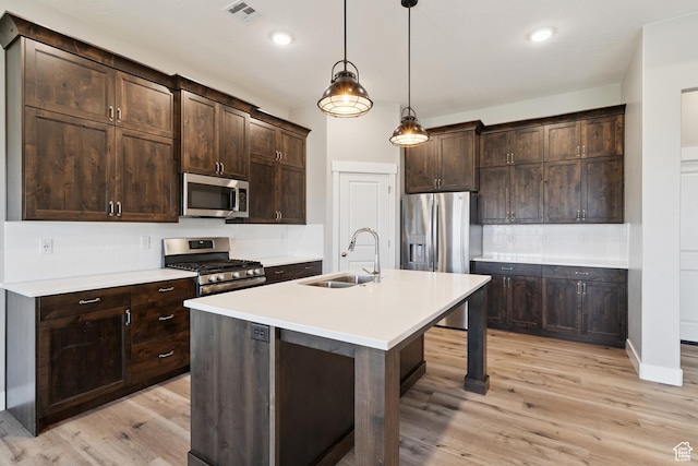 1213 E Marlowe Way, Washington, UT 84780 - kitchen with stainless steel appliances, tasteful backsplash, light wood-style floors, dark brown cabinetry, and recessed lighting