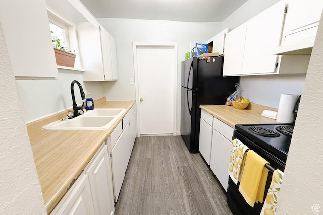 311 W Center St, Springville, UT 84663 - kitchen featuring black appliances, light wood-style floors, white cabinetry, and light countertops