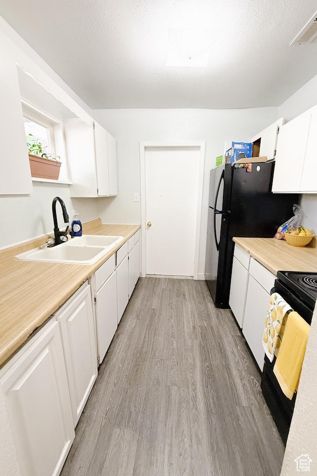 311 W Center St, Springville, UT 84663 - kitchen with light wood-style flooring, white cabinetry, light countertops, and open shelves
