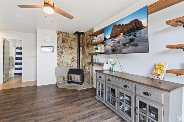 885 S 1650 E Unit B-25, Clearfield, UT 84015 - living area with a wood stove, a ceiling fan, wood finished floors, and a textured ceiling