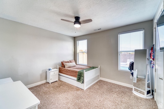 3410 W 2490 S, Hurricane, UT 84737 - bedroom featuring a textured ceiling, light carpet, and a ceiling fan