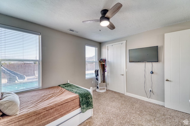 3410 W 2490 S, Hurricane, UT 84737 - bedroom with light colored carpet, a textured ceiling, and a ceiling fan