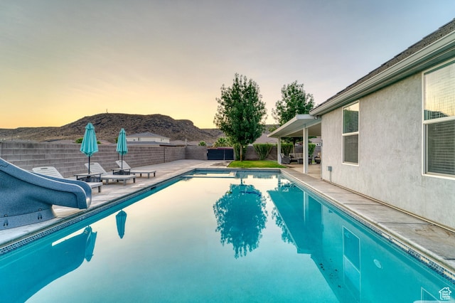 3410 W 2490 S, Hurricane, UT 84737 - view of swimming pool featuring a mountain view, a fenced backyard, a patio, and a water slide